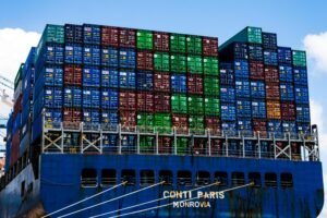 Stacked cargo containers on a massive ship at the harbor, symbolizing global trade.